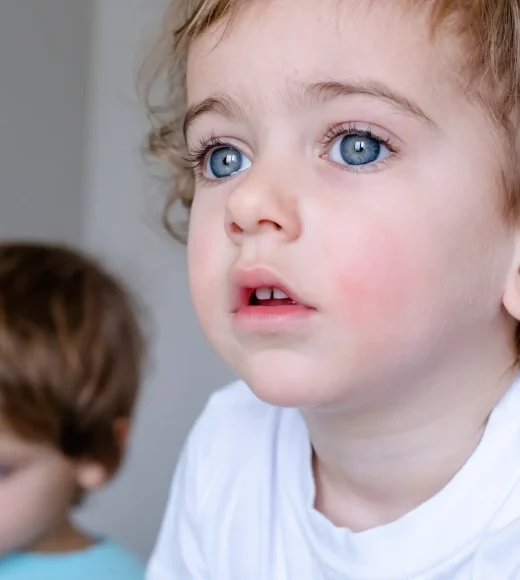 sad look of a cute curly haired child 2 years old